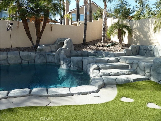 view of pool with a fenced backyard