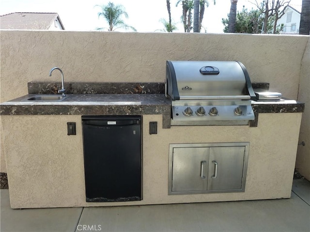 view of patio with grilling area and a sink