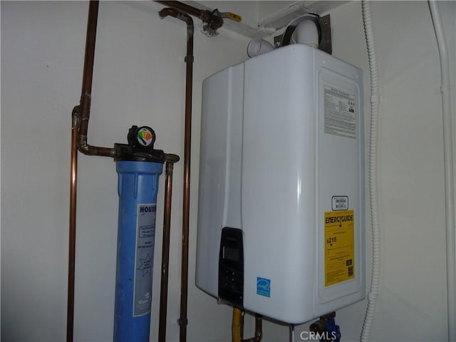 utility room featuring water heater