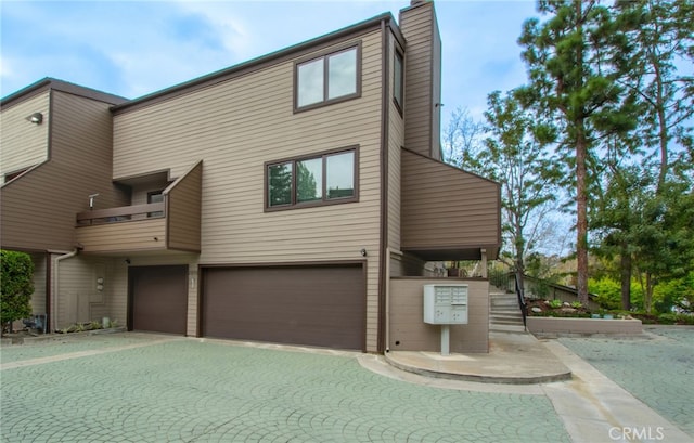 multi unit property with a garage and a chimney