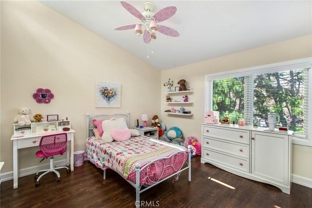 bedroom featuring multiple windows, baseboards, lofted ceiling, and wood finished floors