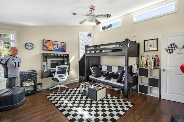 bedroom with dark wood finished floors and baseboards