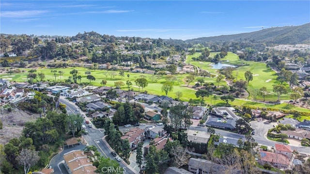 drone / aerial view with golf course view and a residential view