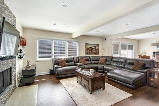 living area with baseboards, a tiled fireplace, beamed ceiling, recessed lighting, and wood finished floors