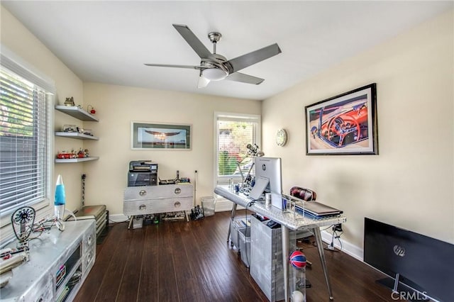 home office featuring dark wood finished floors, a ceiling fan, and baseboards