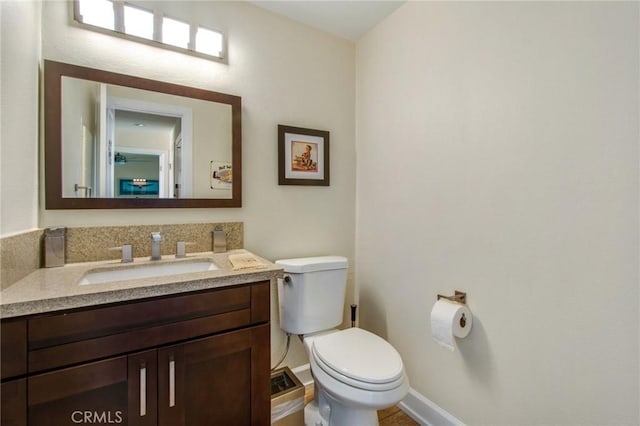 half bathroom with toilet and vanity