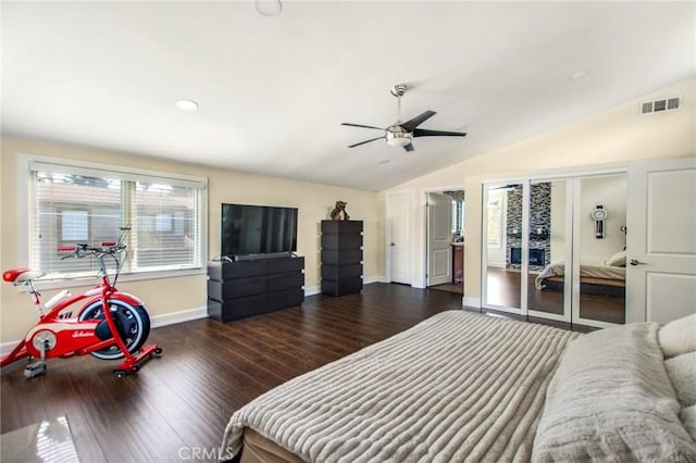 bedroom featuring visible vents, lofted ceiling, wood finished floors, and a ceiling fan