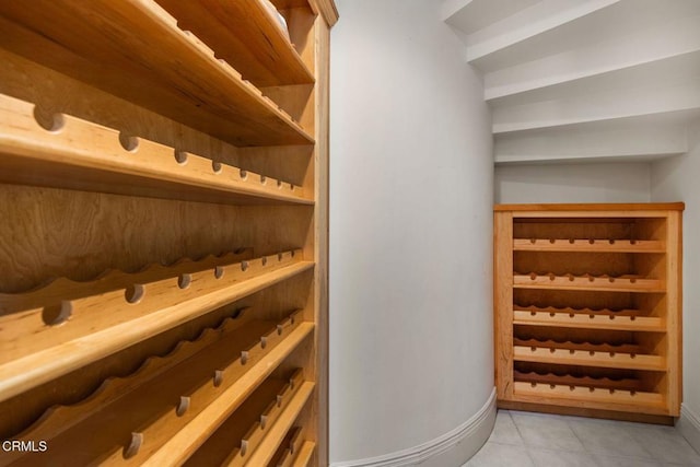 wine area with light tile patterned floors and baseboards