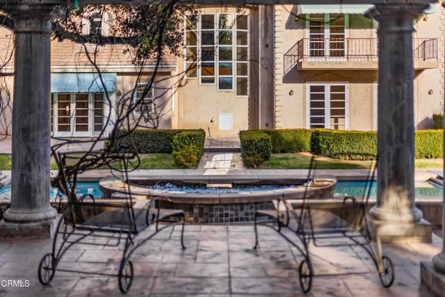 view of patio featuring a balcony