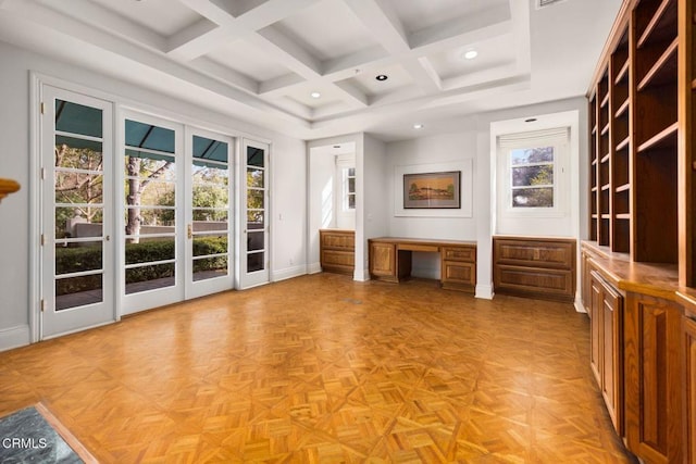 interior space featuring access to exterior, multiple windows, built in desk, and baseboards