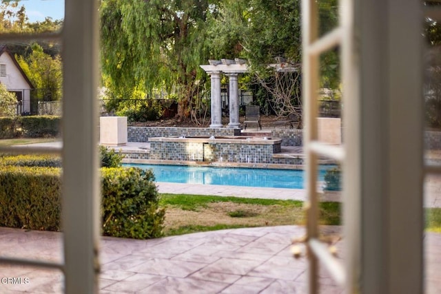 view of pool featuring fence