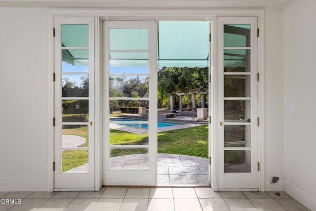 doorway to outside featuring baseboards