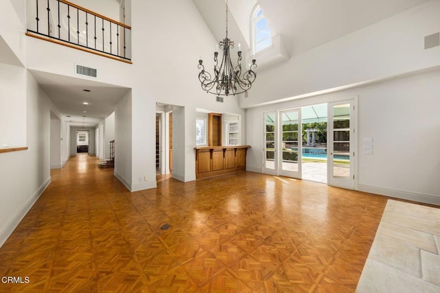 interior space featuring stairway, baseboards, visible vents, and a notable chandelier