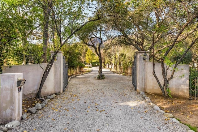 508 W Eucalyptus St, Ojai, CA 93023 - view of dirt / gravel driveway featuring a gate, a gated entry, and view of scattered trees