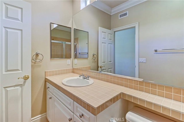 bathroom with ornamental molding, visible vents, vanity, and toilet