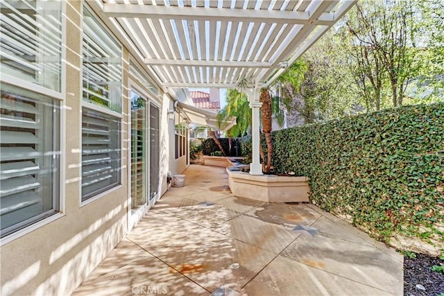 view of patio / terrace featuring fence and a pergola