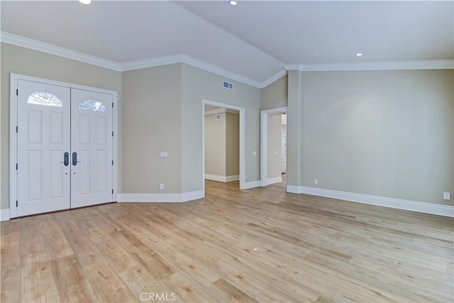 entryway featuring light wood-style floors, lofted ceiling, ornamental molding, and baseboards