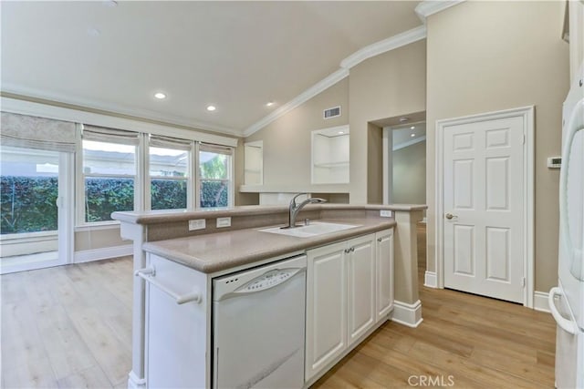 kitchen with visible vents, dishwasher, crown molding, white cabinetry, and a sink