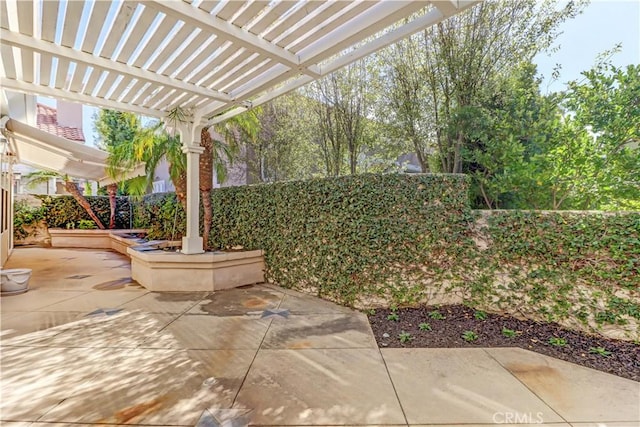 view of patio featuring fence and a pergola