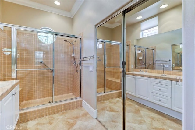 full bathroom featuring recessed lighting, vanity, a shower stall, tile patterned floors, and crown molding