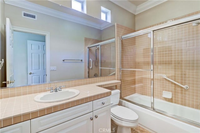 bathroom featuring crown molding, visible vents, toilet, enclosed tub / shower combo, and vanity