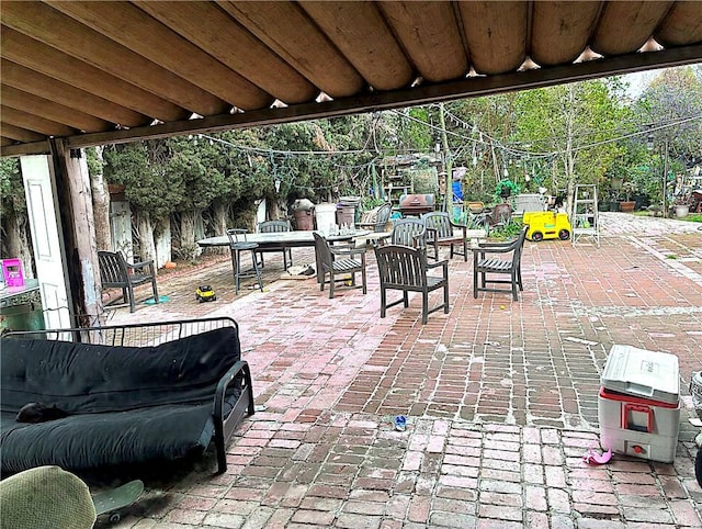 view of patio / terrace featuring outdoor dining space and a grill