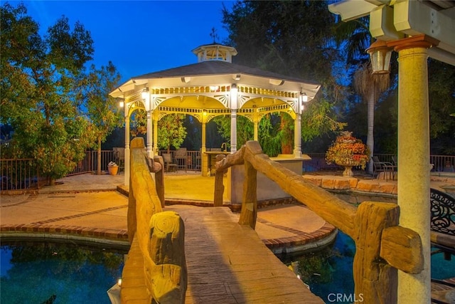 exterior space featuring a gazebo, a patio, and fence