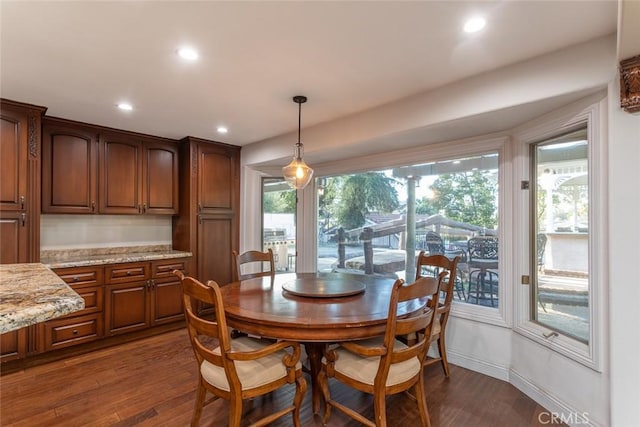 dining area with baseboards, dark wood finished floors, and recessed lighting