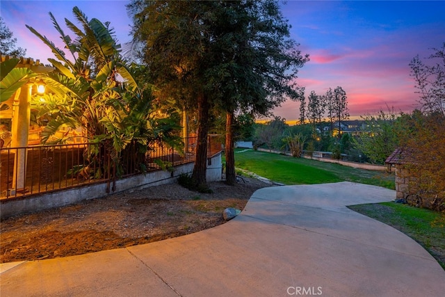 view of property's community with a yard and a patio