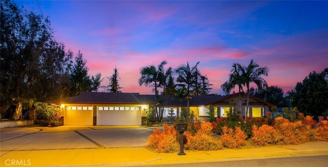 single story home featuring a garage and driveway