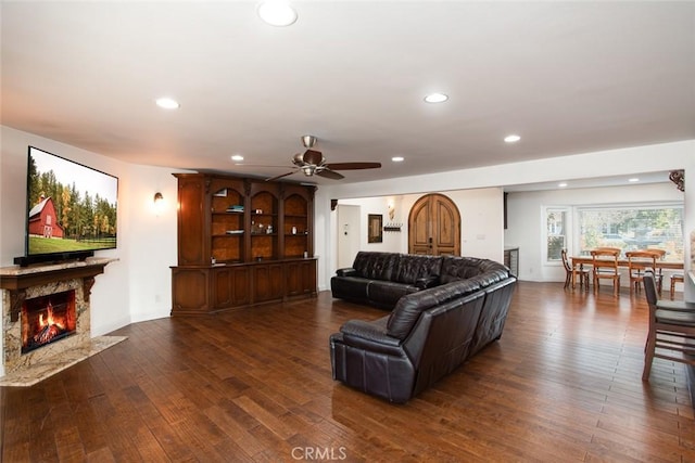 living room featuring ceiling fan, wood-type flooring, a high end fireplace, and recessed lighting