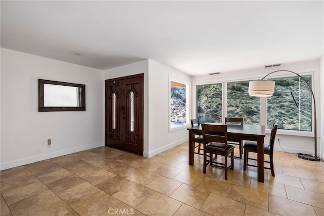 dining space with visible vents, baseboards, and a wealth of natural light