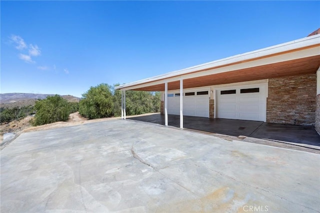 garage featuring a carport and a mountain view