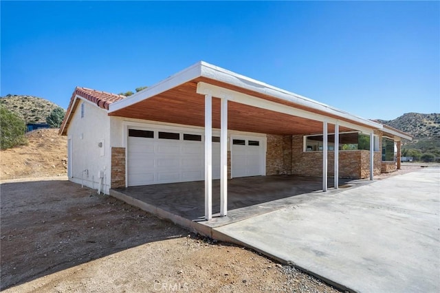 garage with a carport and a mountain view