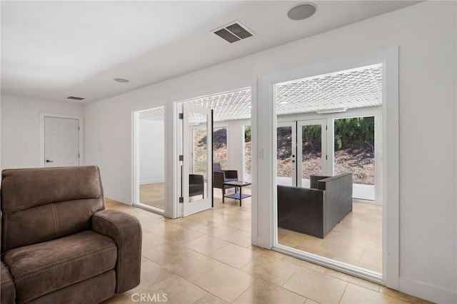 interior space with french doors, visible vents, and baseboards