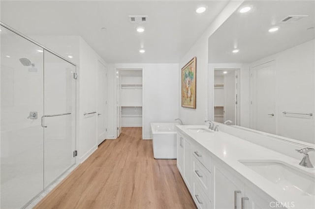 full bathroom with visible vents, a sink, and a shower stall