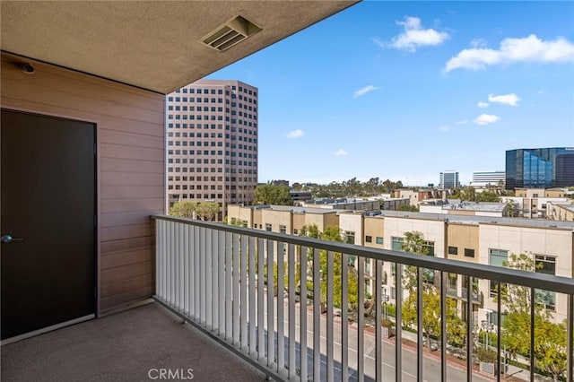 balcony featuring visible vents and a city view