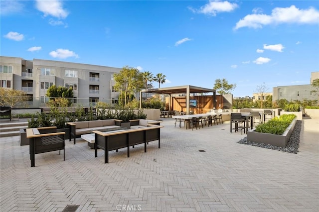 view of community featuring outdoor dry bar, a patio, and an outdoor living space