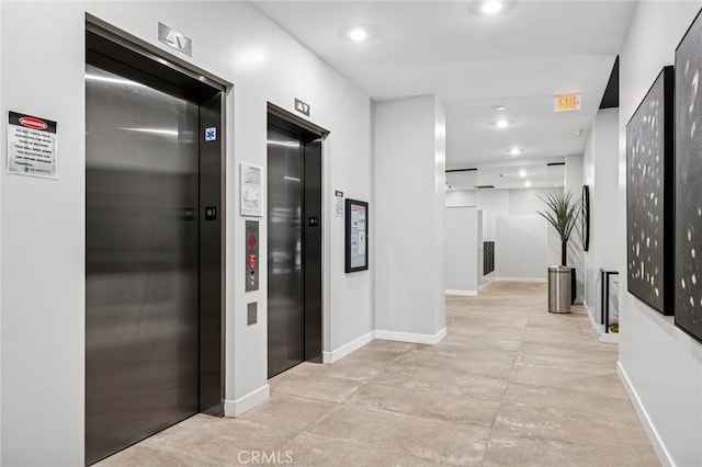 corridor featuring recessed lighting, elevator, and baseboards