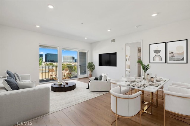 living area featuring visible vents, wood finished floors, and recessed lighting