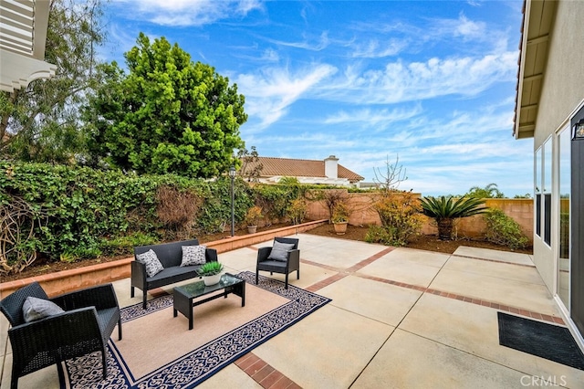 view of patio featuring a fenced backyard and an outdoor living space