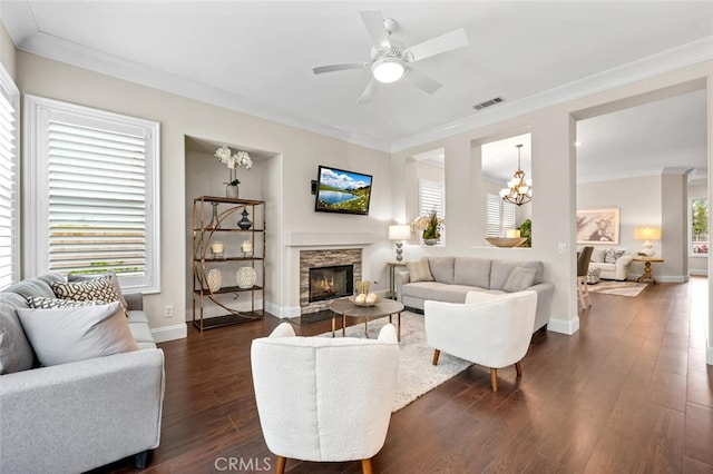 living room with plenty of natural light, dark wood finished floors, and crown molding