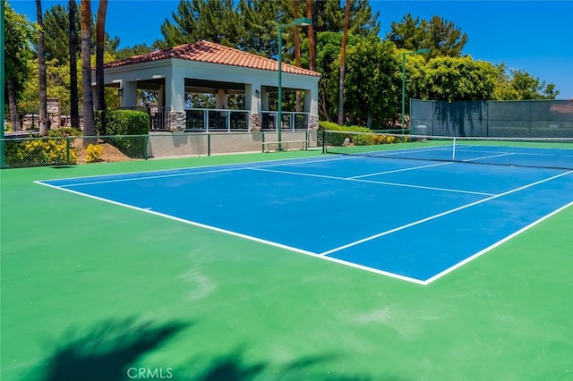 view of sport court featuring a gazebo and fence