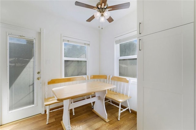 dining area featuring ceiling fan, breakfast area, plenty of natural light, and light wood-style flooring