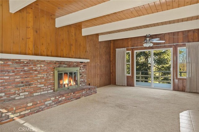 27008 Everest Rd, Lake Arrowhead, CA 92352 - unfurnished living room featuring beamed ceiling, wood walls, a brick fireplace, carpet, and a ceiling fan