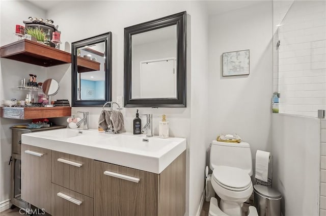 full bath featuring a sink, toilet, and double vanity