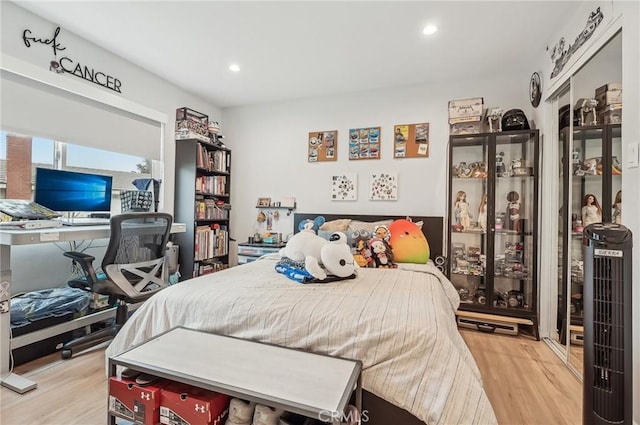 bedroom featuring recessed lighting and wood finished floors