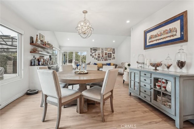 dining space featuring lofted ceiling, light wood finished floors, recessed lighting, and a notable chandelier