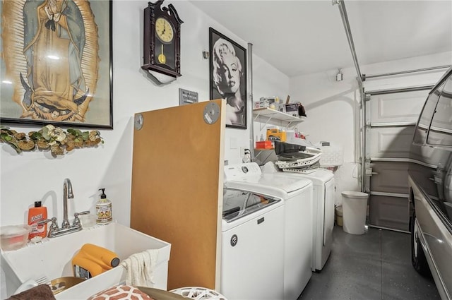 laundry area featuring a garage, a sink, and washer and dryer