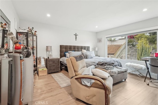 bedroom with recessed lighting and light wood-style floors